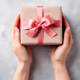 two hands offering a wrapped gift