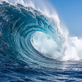 large ocean wave against a blue sky